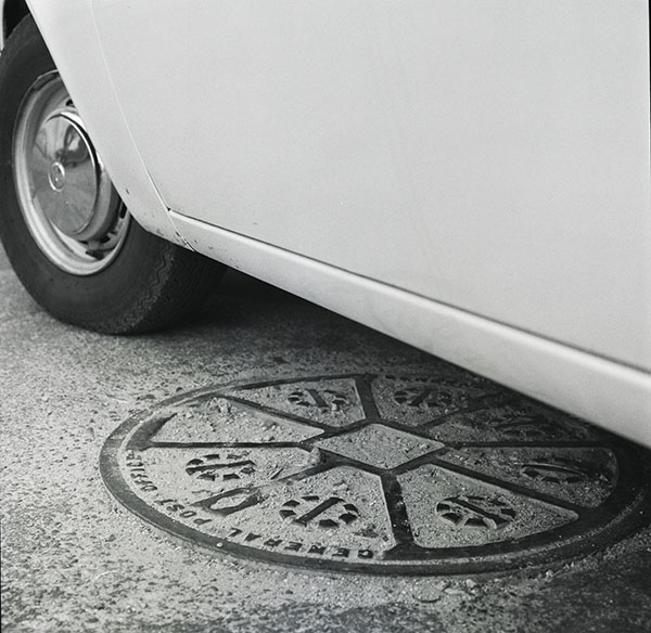 Car over manhole, 1979