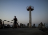 Lighthouse and walker at dusk, Herzlia Marina, 2003